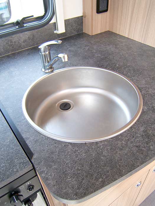 The recessed stainless steel sink with single mixer tap.